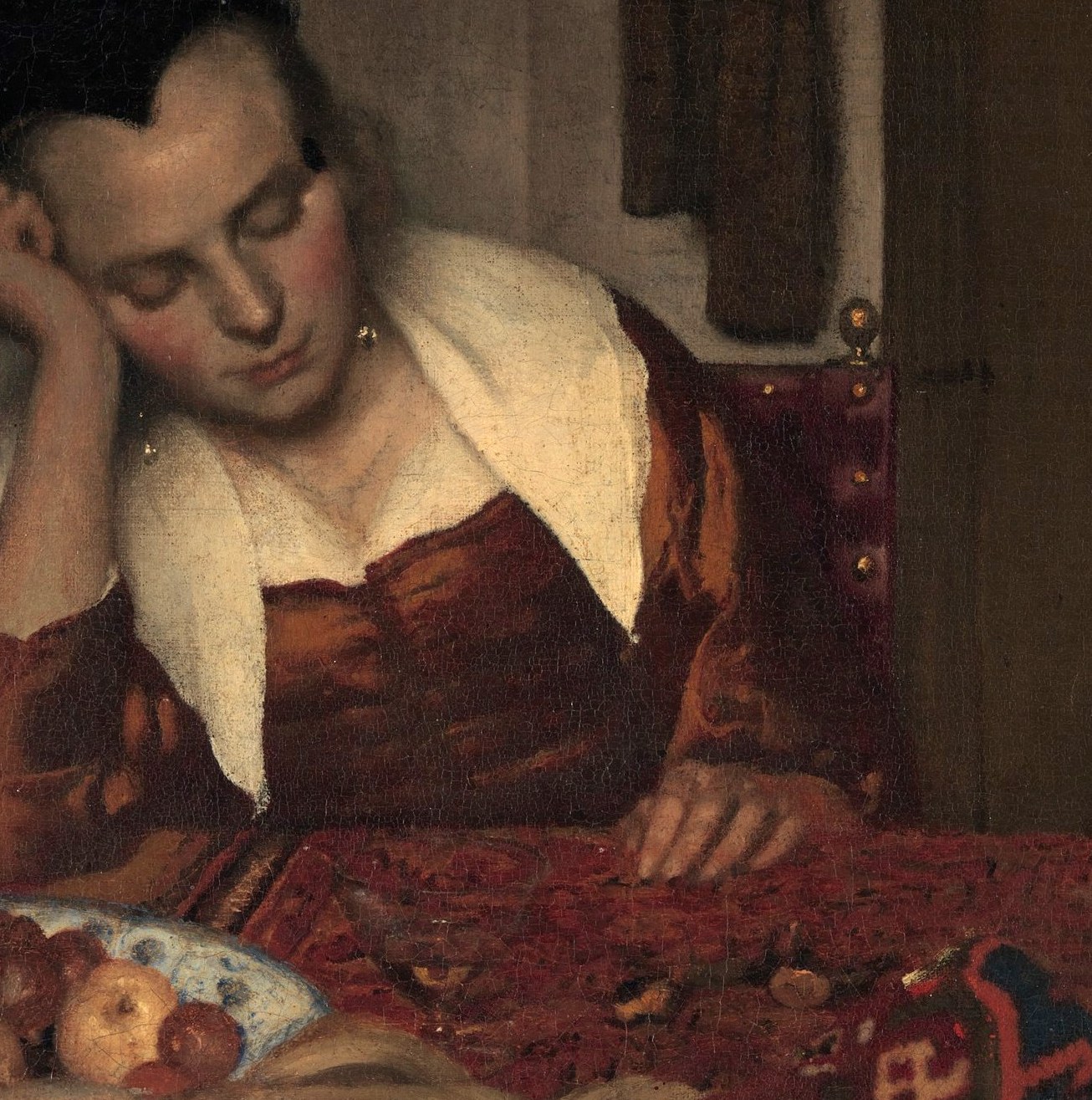 Vermeer's signature color anchor , the warm orange reads immediately against the dark ground, showing his mastery of chromatic hierarchy