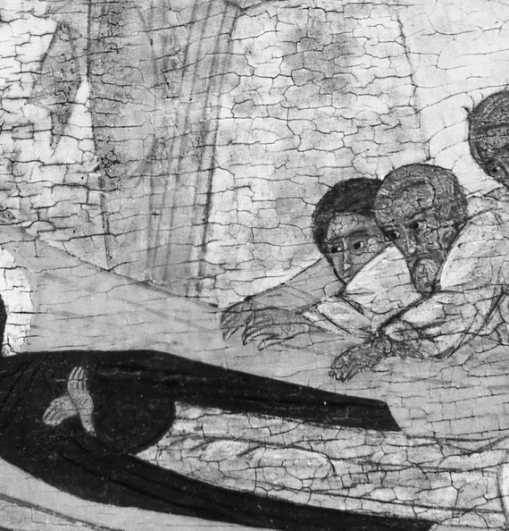 The apostles bow their heads, lost in grief.