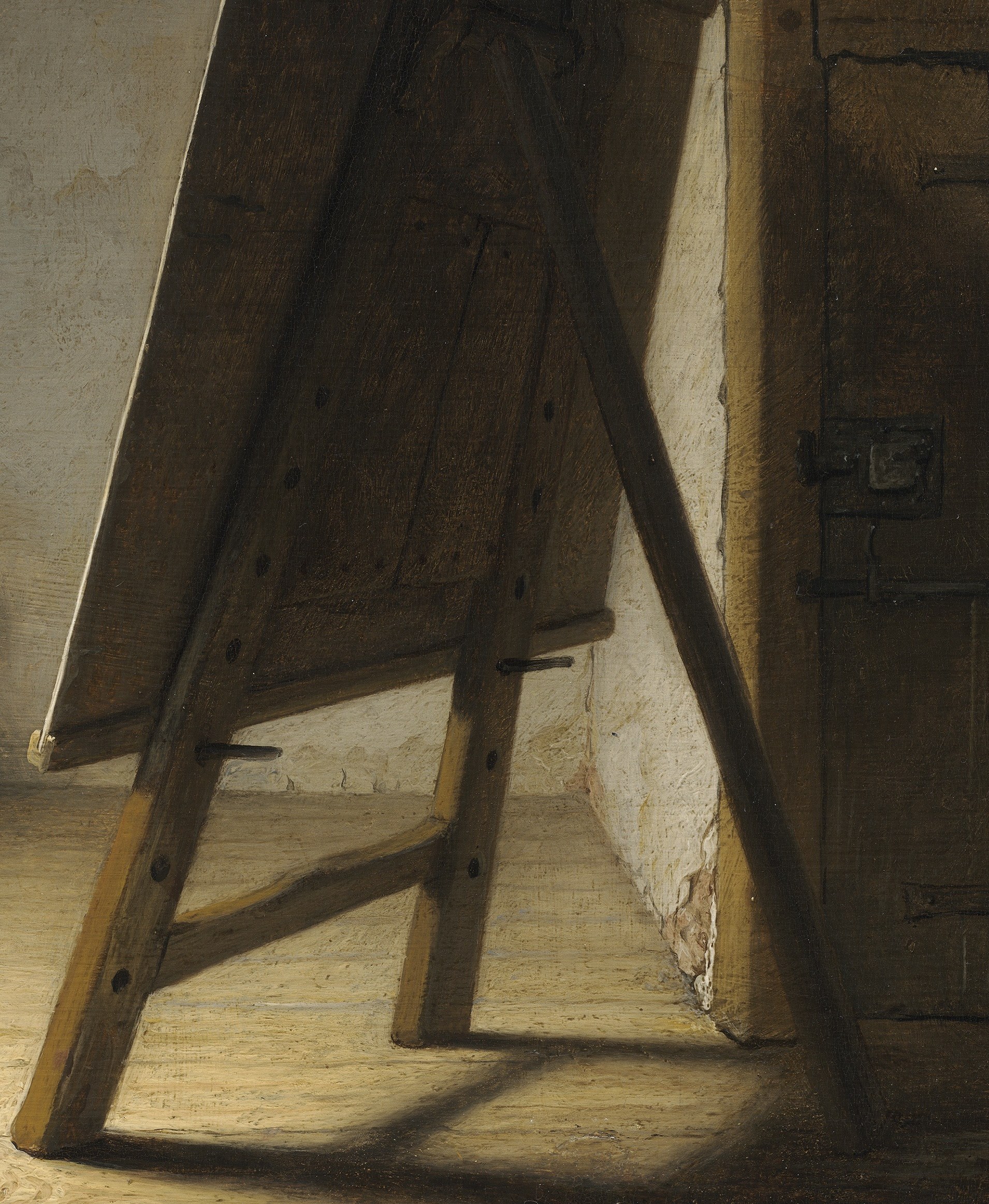 He stands far from his easel, considering the blank canvas.
