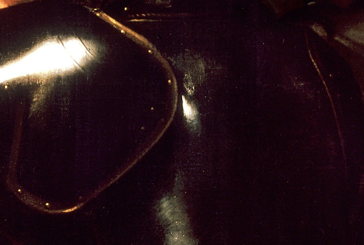 The helmet. A few strokes of white make polished steel.