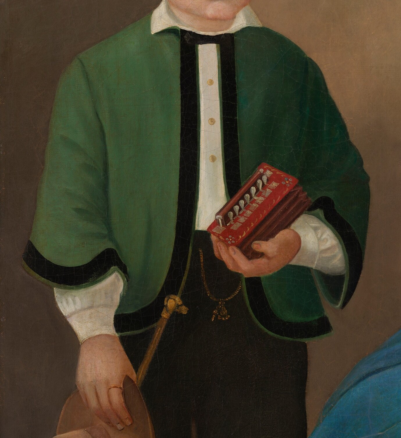 His serious face in a green jacket shows privilege.