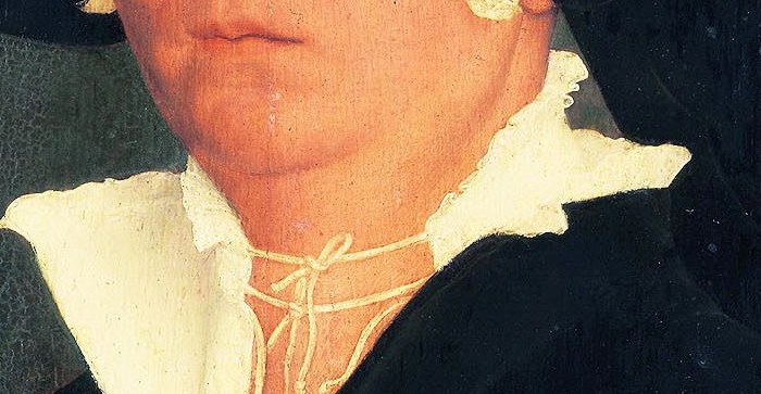 The crisp white linen provides a stark contrast to her dark attire, highlighting the texture and cleanliness of her garments.