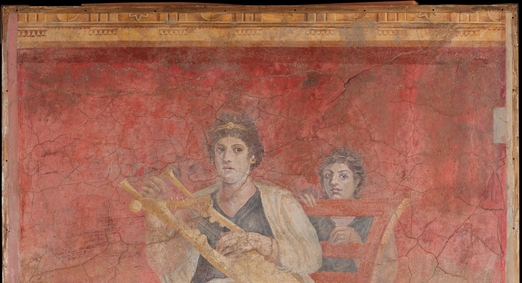 The saturated Pompeian red (cinnabar or hematite) has survived nearly 2,000 years; its evenness shows the plaster was prepared in large, expertly timed sections.