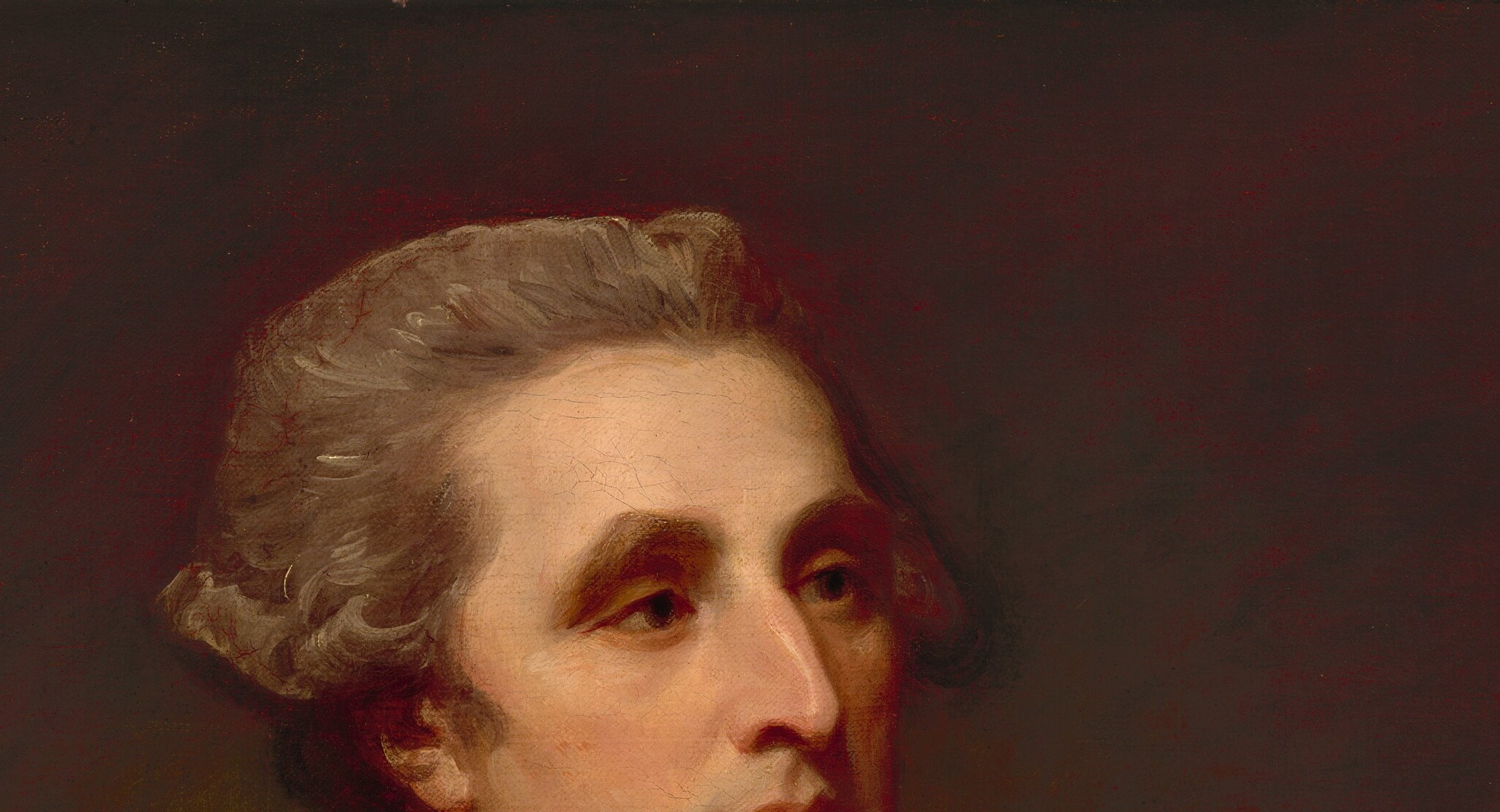 Classic late 18th-century court wig anchors the portrait historically; the pale hair throws the ruddy face into warm relief, a deliberate Romney compositional choice.