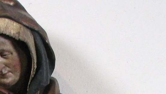 The downcast eyes, the furrowed brow, grief carved in limewood.