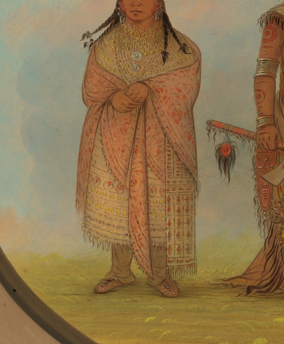 The intricate geometric patterns and soft texture of the shawl convey a sense of warmth and cultural artistry.