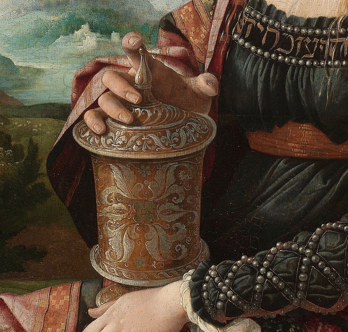 The defining iconographic attribute that identifies this figure as Mary Magdalene; the spikenard jar alludes simultaneously to the anointing of Christ's feet and her visit to the empty tomb , one object carrying two narrative moments.