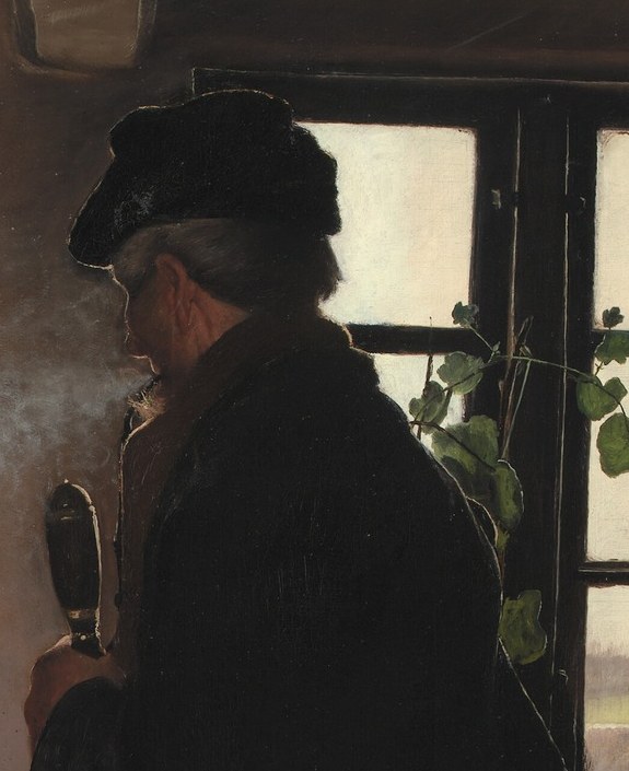 His profile is framed by the window light.