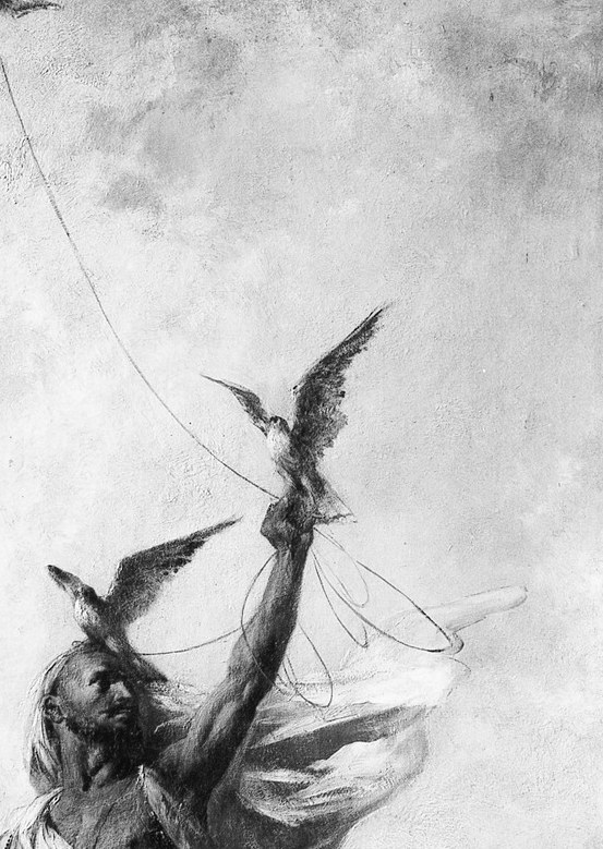 One hand releases a bird into the pale desert air.