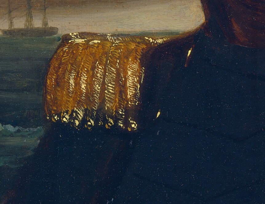 The gold epaulets on his shoulders are insignia of authority.