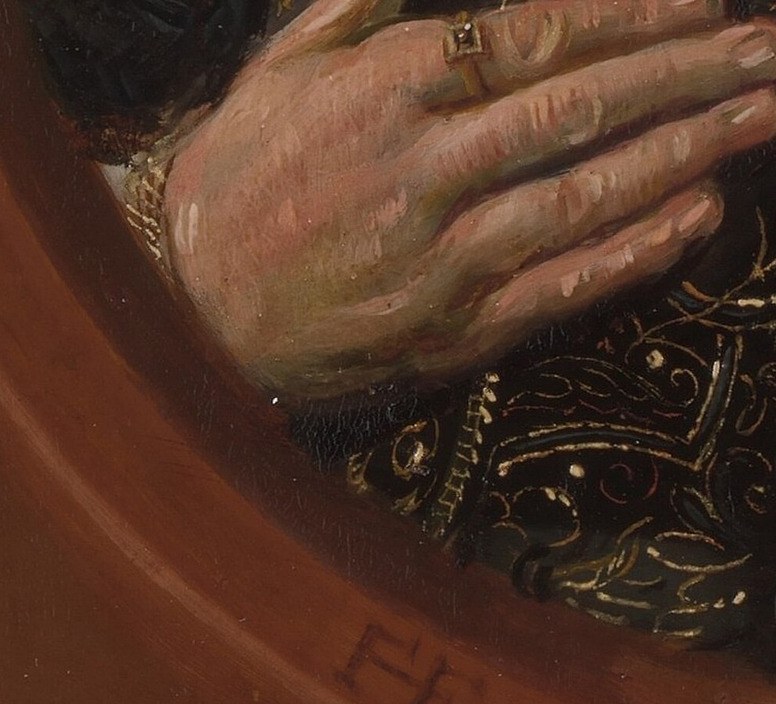 Her hand rests on her chest, a gesture of sincerity.