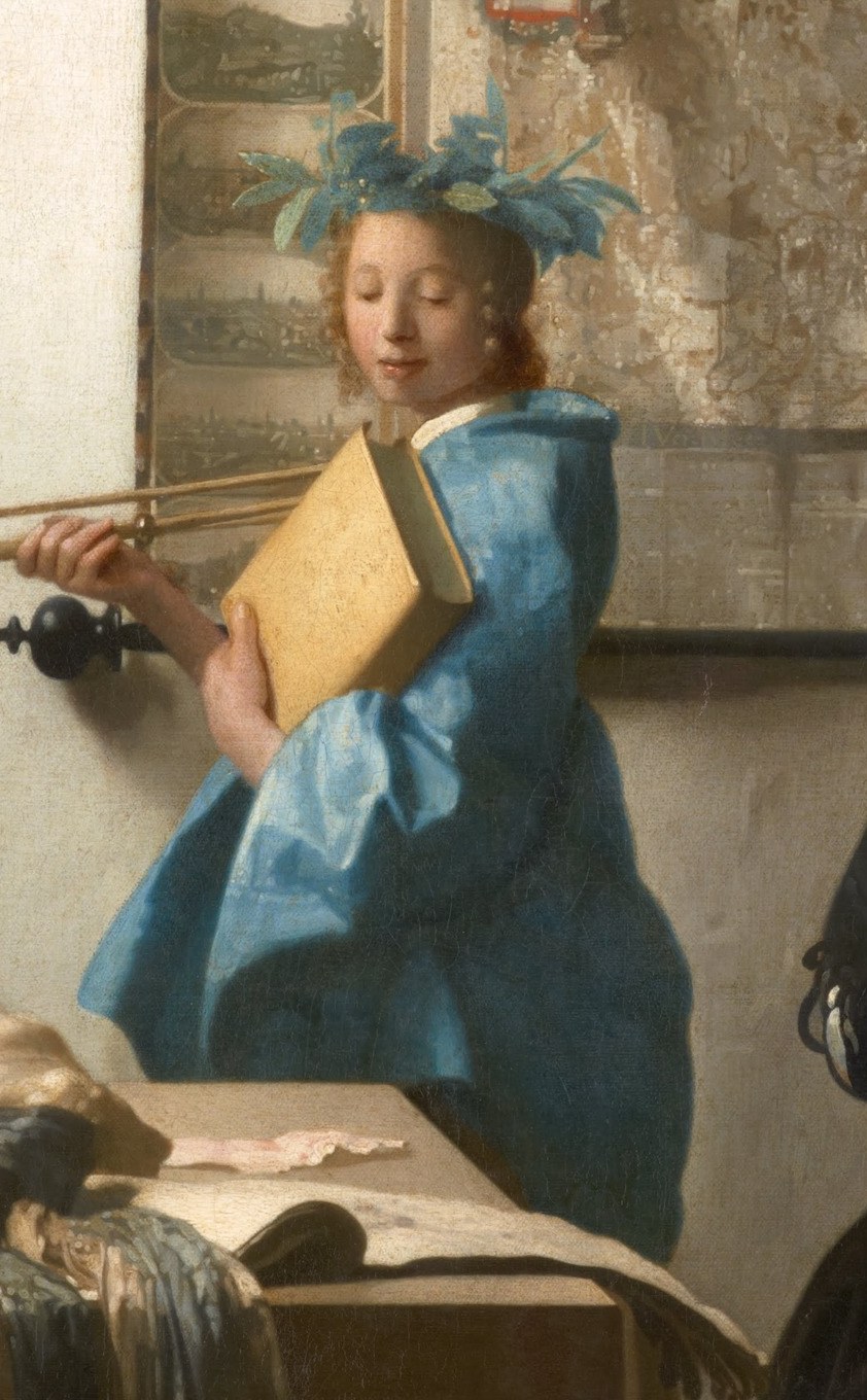 The blue-clad model poses like a muse.