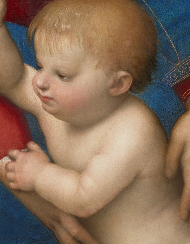 The child grasps it with divine strength.