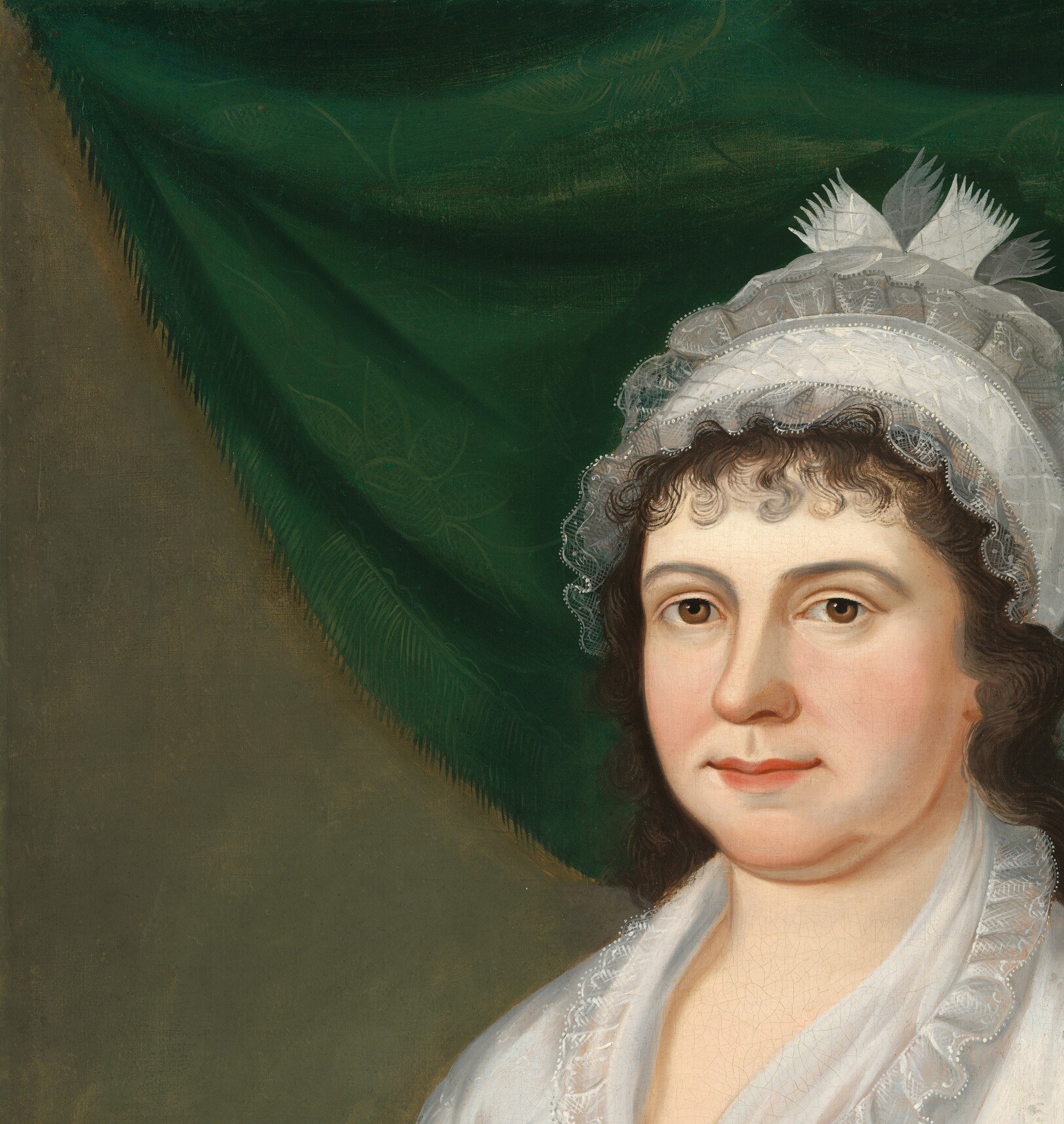 The rich, textured drapery creates a dramatic backdrop, highlighting the sitter and adding depth to the scene.