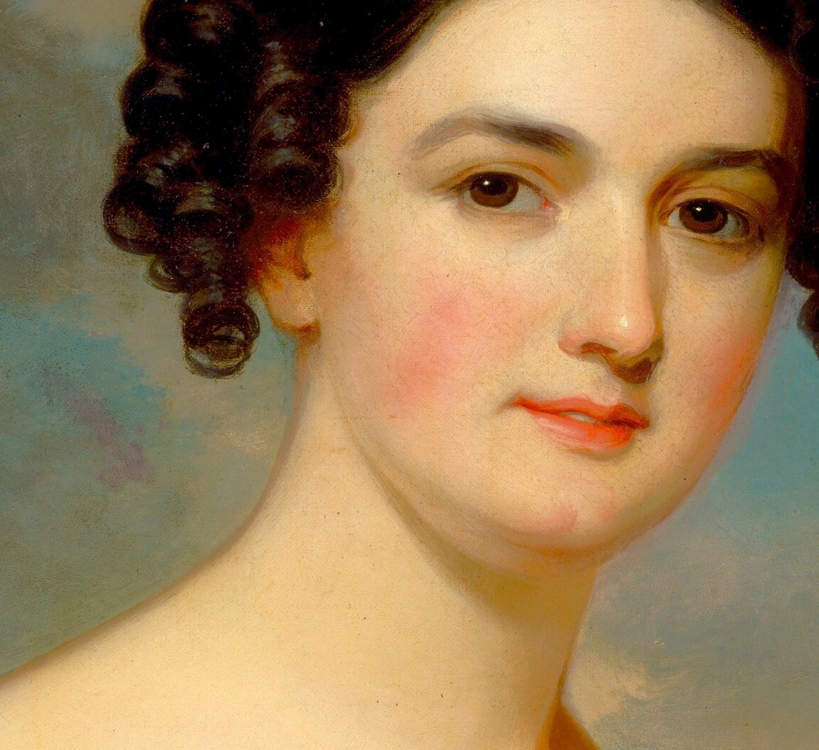 Her direct gaze invites a silent conversation with the viewer.