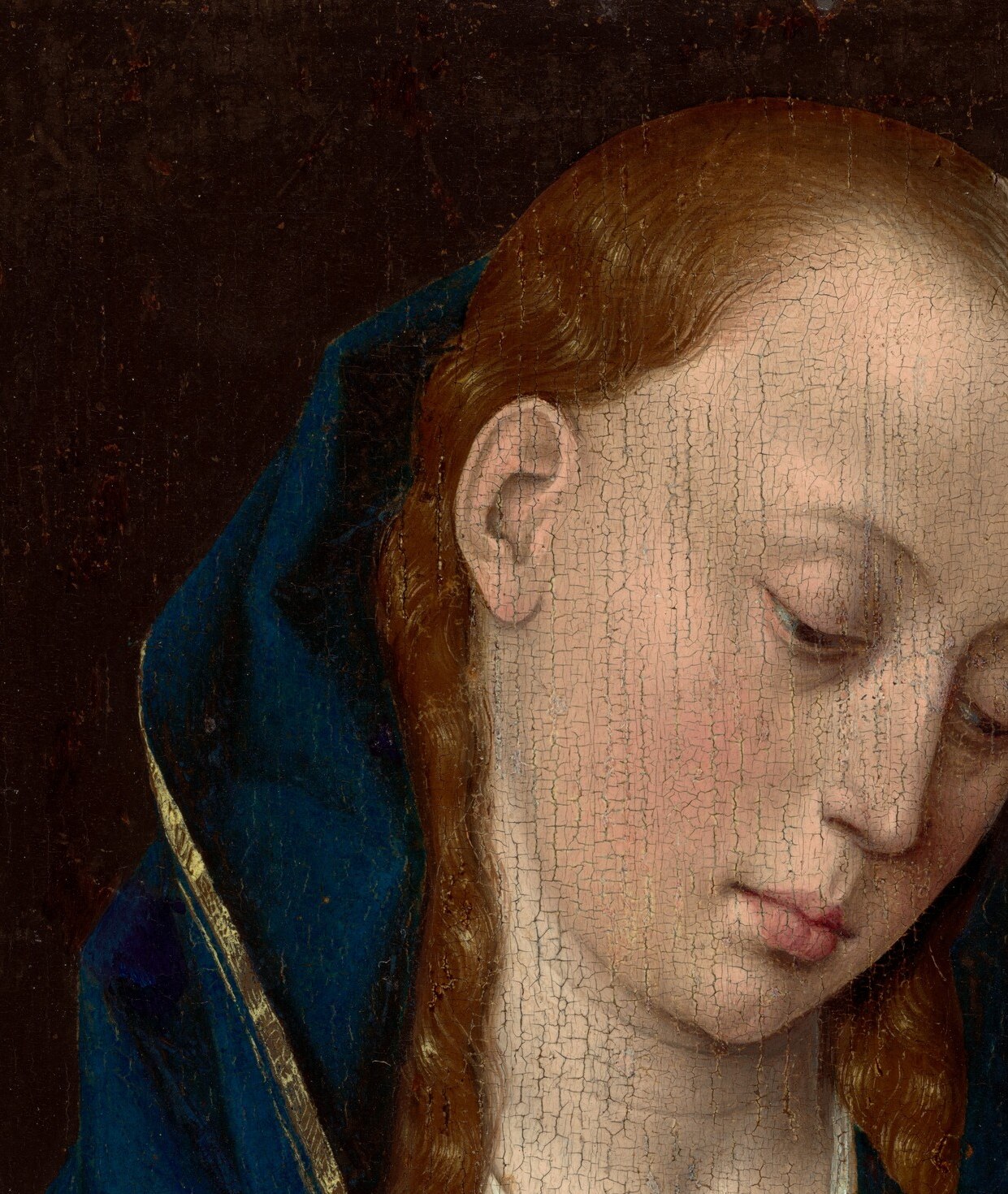 Her eyes are cast slightly downward with composed, inward serenity , the emotional anchor of the composition; Bouts renders her features with the cool idealism typical of Netherlandish devotional portraiture.