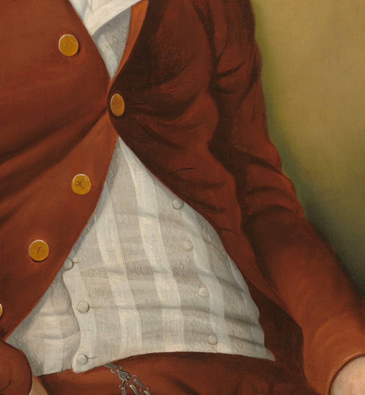 The intricate pattern and crisp white offer a visual contrast to the red coat.