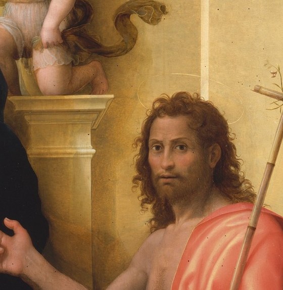 The rugged bearded face contrasts with the Madonna's refinement; his wilderness origins read in every weathered feature.