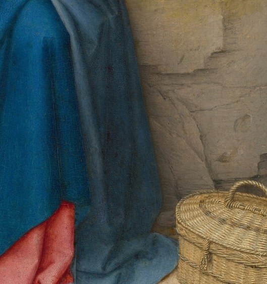 A finely woven reed basket , likely holding provisions , is a grounding domestic detail that roots the sacred scene in everyday Flemish life.