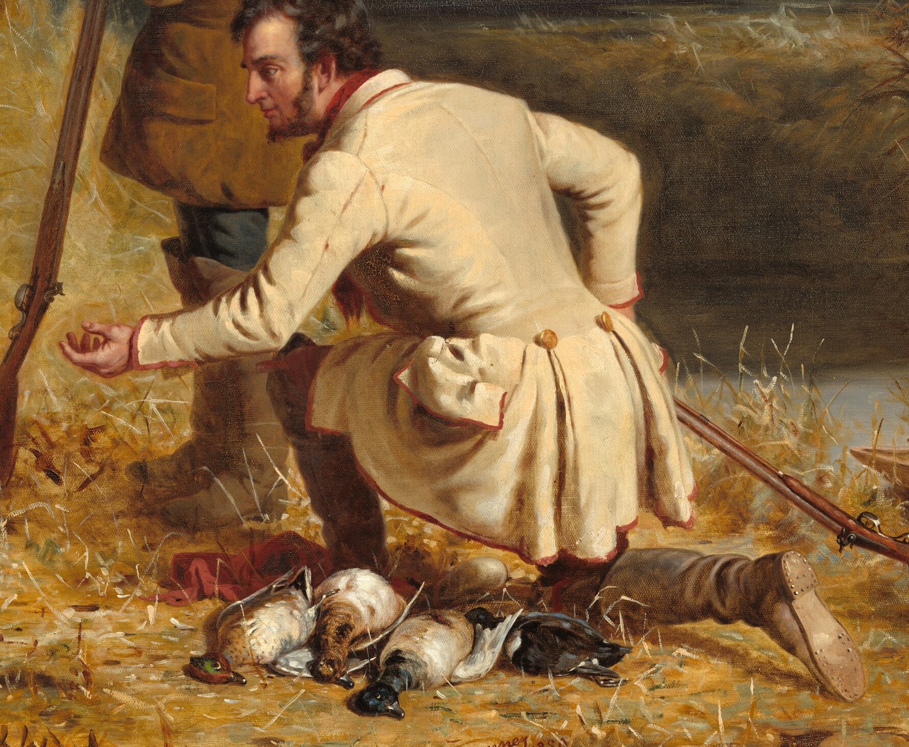 His crouched position and outstretched hand create a focal point of interaction with the dog.