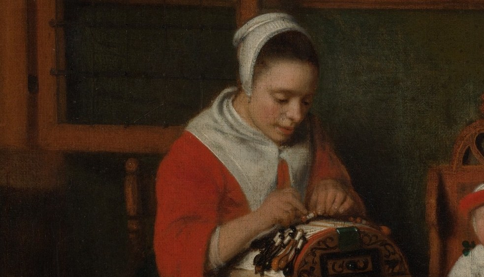 The lace pillow with bobbins is the painting's title subject; the hands hovering over it illustrate a skilled domestic craft that was commercially significant in 17th-century Holland.