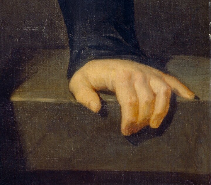 His left hand rests with quiet confidence.