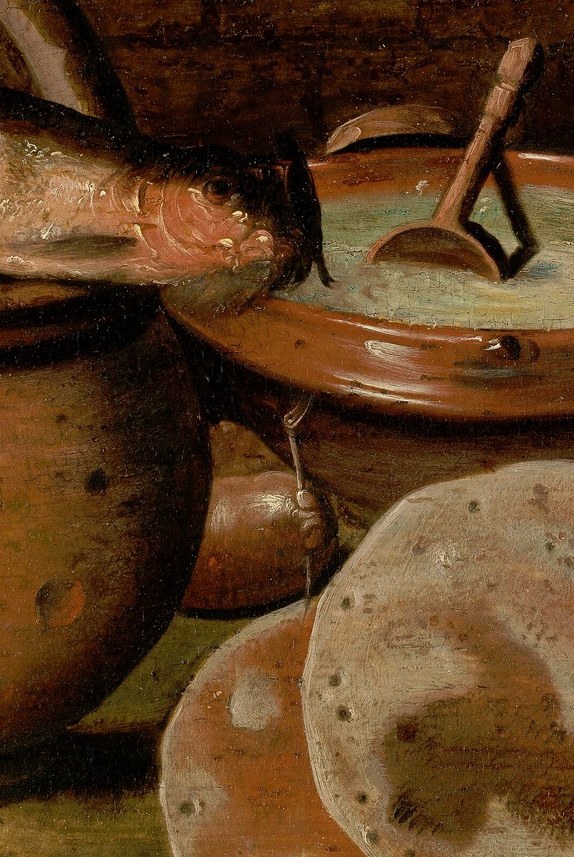 The rough texture of the pot and the glistening scales of the fish suggest a tactile experience, highlighting the raw ingredients of the meal.
