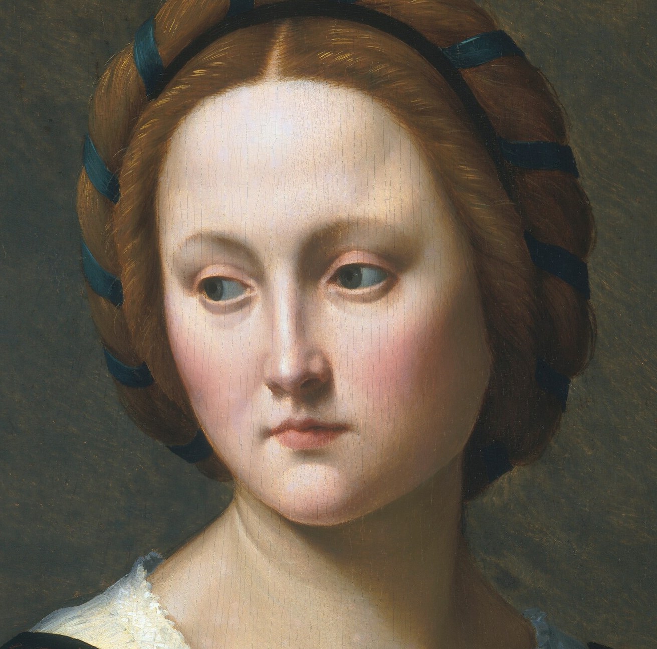 Her gaze is averted, suggesting introspection or perhaps a subtle defiance, drawing the viewer into her inner world.