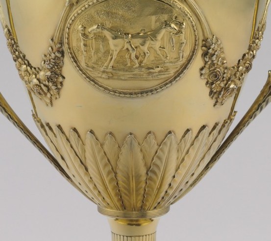 Radiating lines that give the urn a sense of volume and taper towards the base.