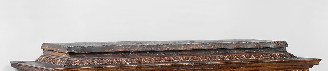 Deep-relief carved moldings frame the painting like a stage proscenium , the furniture itself is art, and this carved surround is from the original Florentine workshop, unlike the panel it frames.