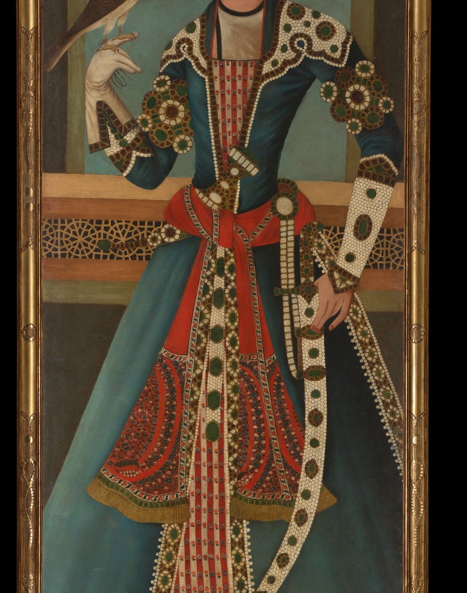 The dominant blue-and-gold palette was associated with royal manufacture; the all-over floral repeat shows textile wealth that could only be imported or produced by court workshops.