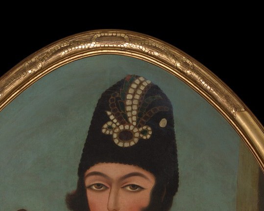Every surface announces his rank, from the jeweled headdress