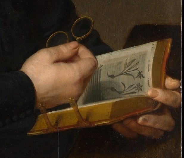 His careful hands suggest a life of study and precision.