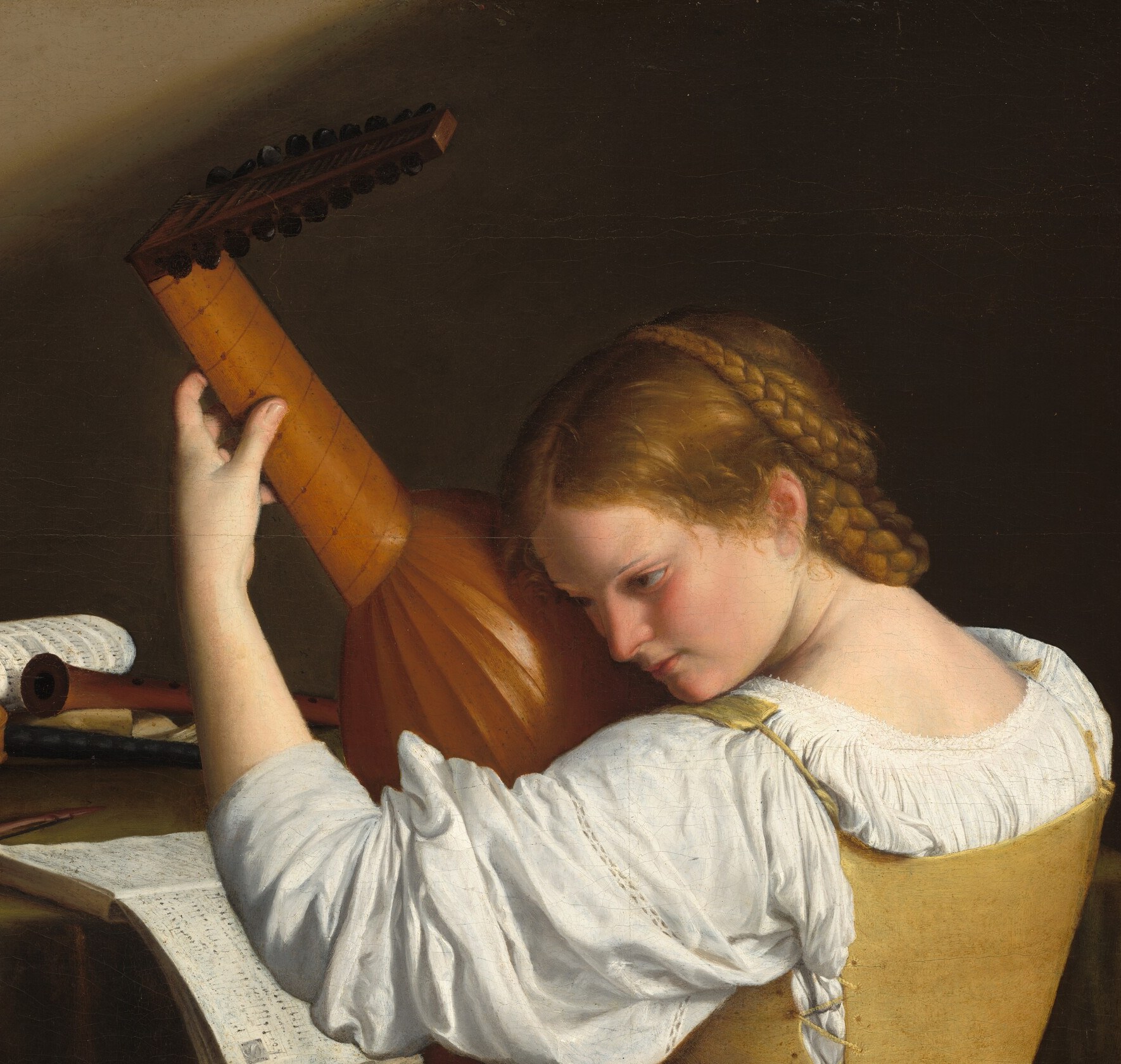 The light slides across the lute's curved body.