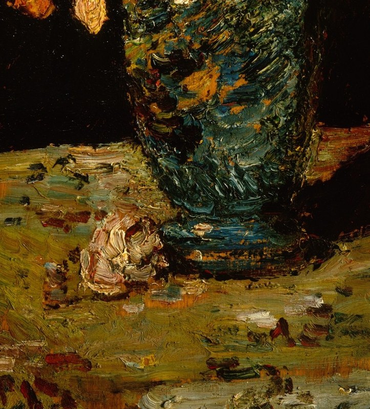 The central anchor of the composition; its blue-and-gilt patterning contrasts sharply with the dark background and rewards close inspection of the decorative motifs painted on its surface.