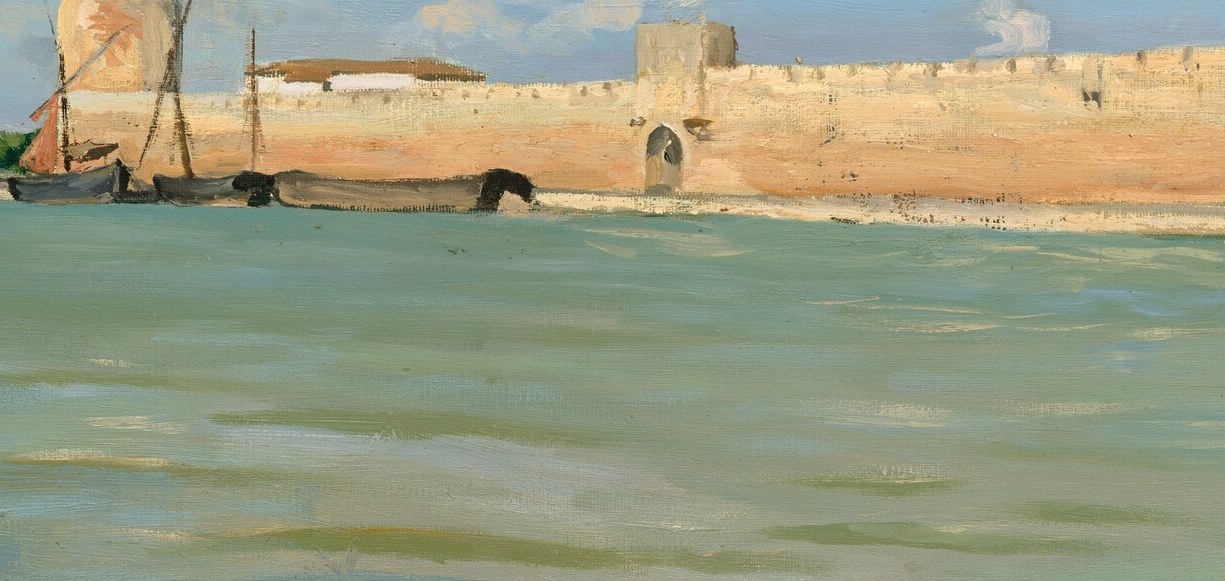 A working boat rests at the base of a medieval prison wall.