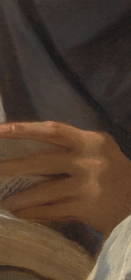 His gnarled hands grip the sacred text.