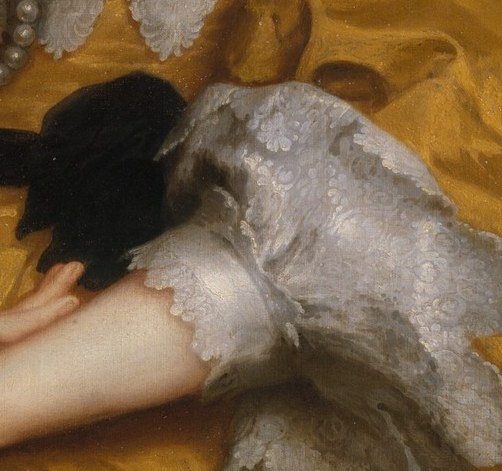 Look at what she holds against her yellow silk.