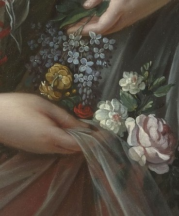 Notice her delicate hands, holding a small bouquet.