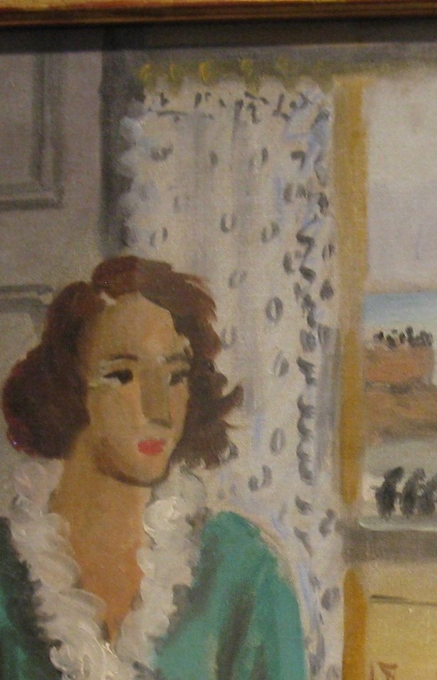 Look closely at the window, beyond the lace curtain.