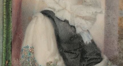 The contrast between the dark fabric and her pale skin emphasizes her features.
