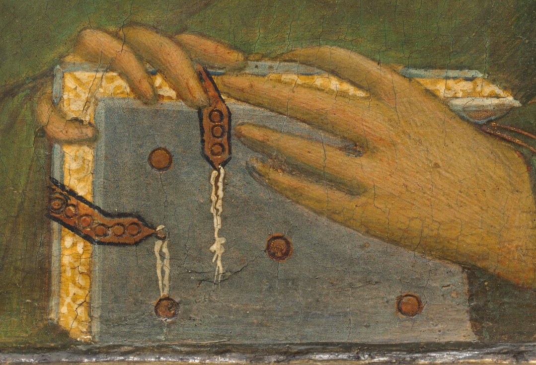 This attribute is a key symbol of his wisdom and the sacred texts he would have studied or preached.