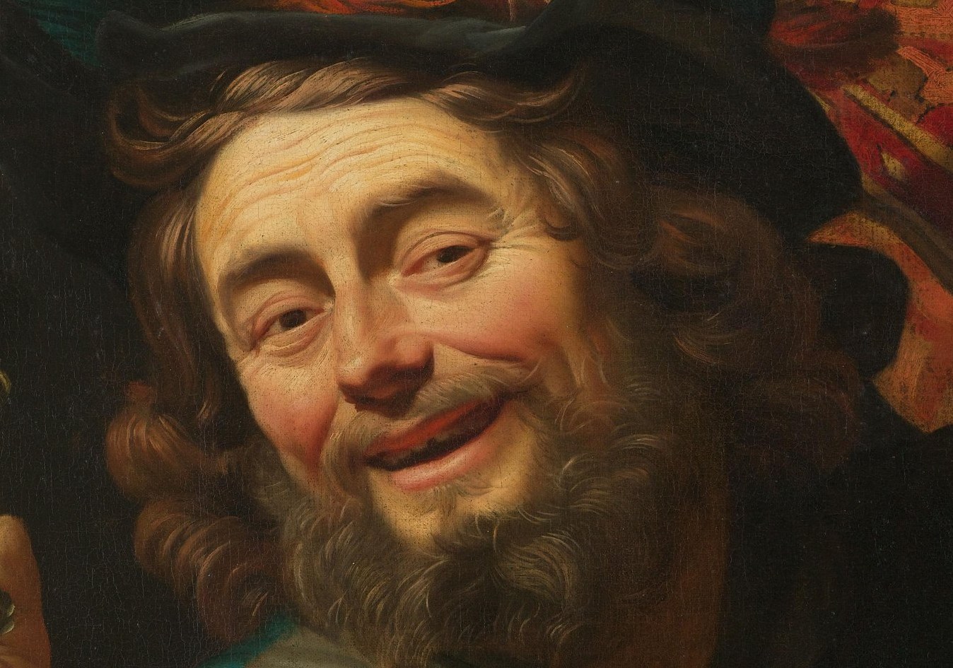 With a wide grin, he leans into our space.