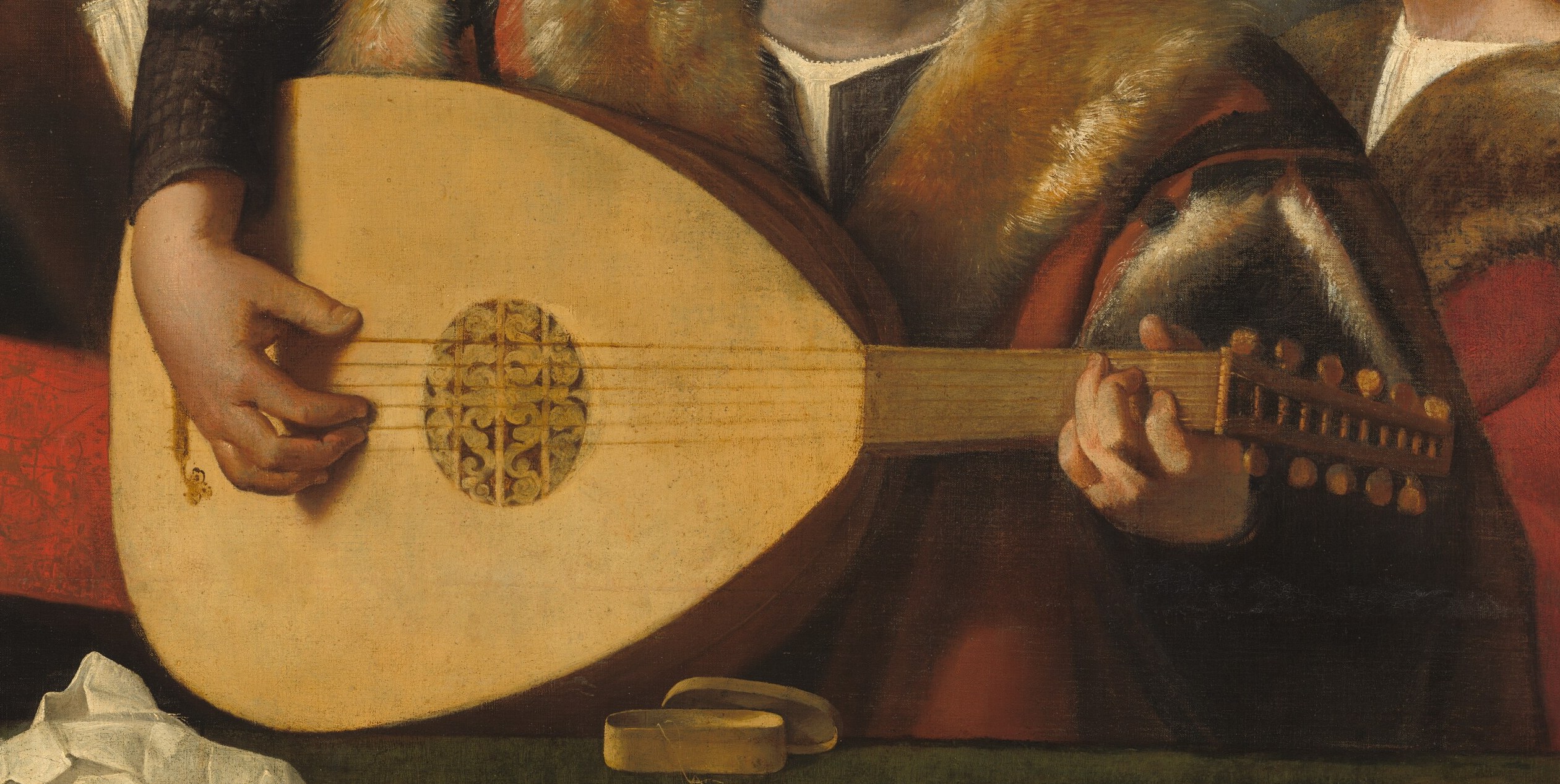 The instrument dominates the foreground, its smooth, curved surface and detailed soundhole drawing the eye.