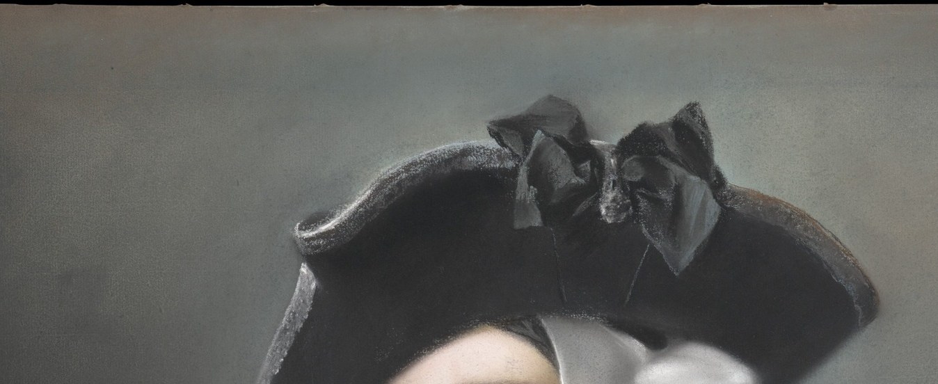 The defining headpiece of the Venetian masquerade; its wide dark brim creates a canopy that both frames and partially shadows the face, enacting concealment from above.