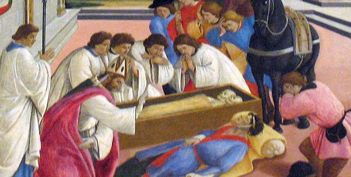 The dead or dying figure is the visual and theological crux of the central miracle; its horizontal weight against the upright crowd creates a visual shock a camera can linger on.