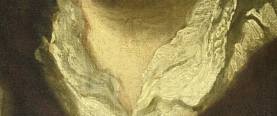 And the delicate lace of his collar.