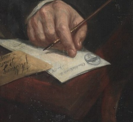 Look closely at the document he's working on.