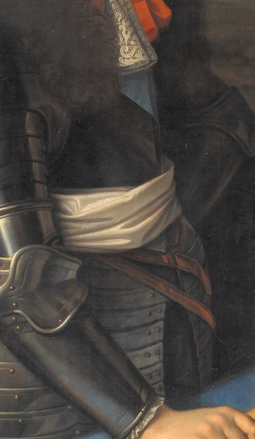 His polished armor reflects his military ambition.