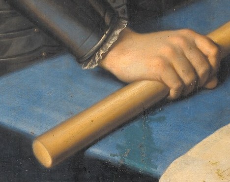 He is dressed for battle, holding a commander's baton.